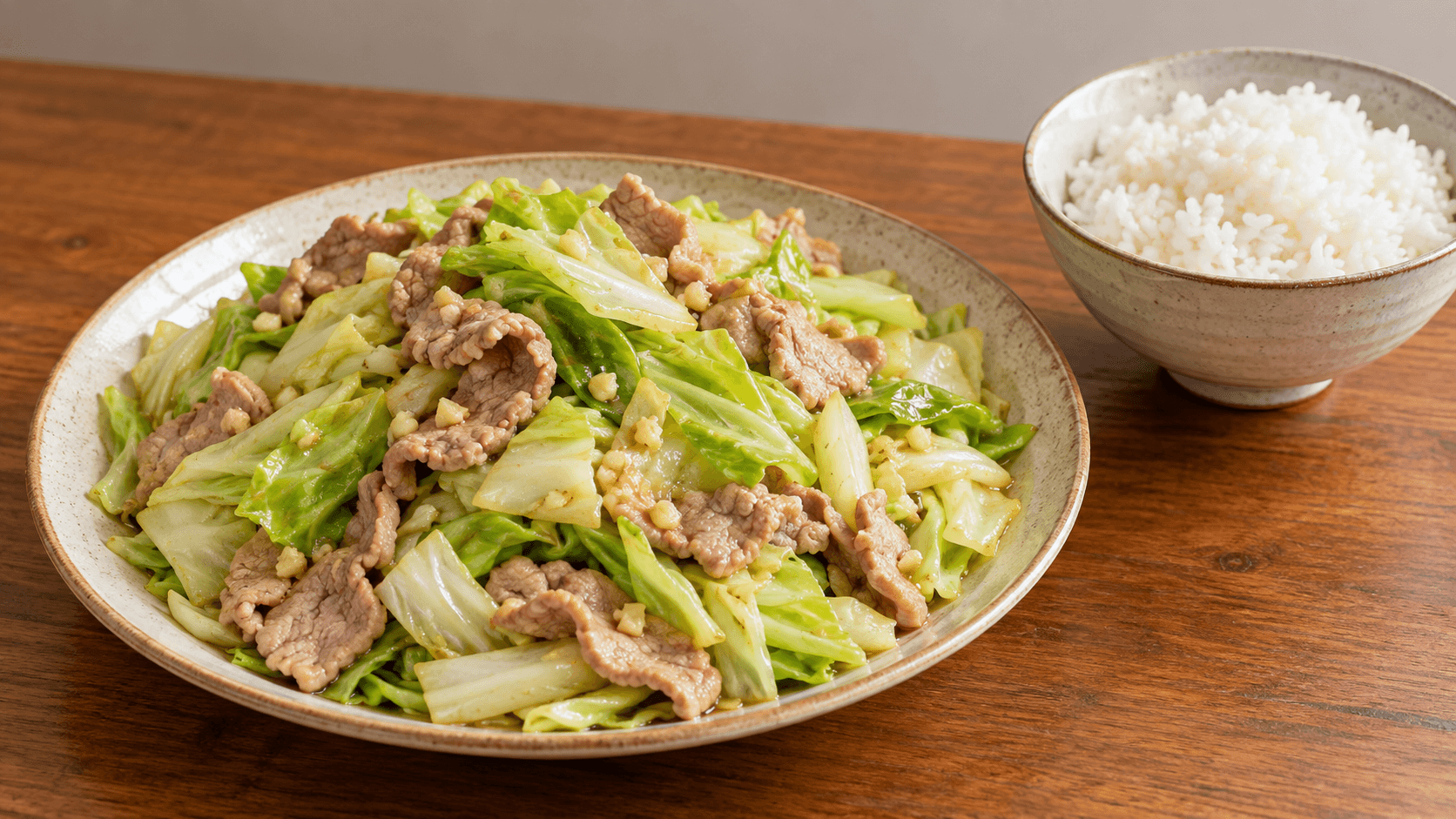 蒜香甘藍炒豬肉配一碗白飯的家常餐桌情境